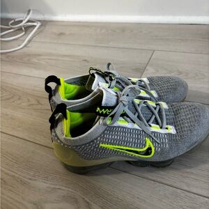 Nike Air VaporMax Flyknit model in a grey with volt (neon yellow/green).